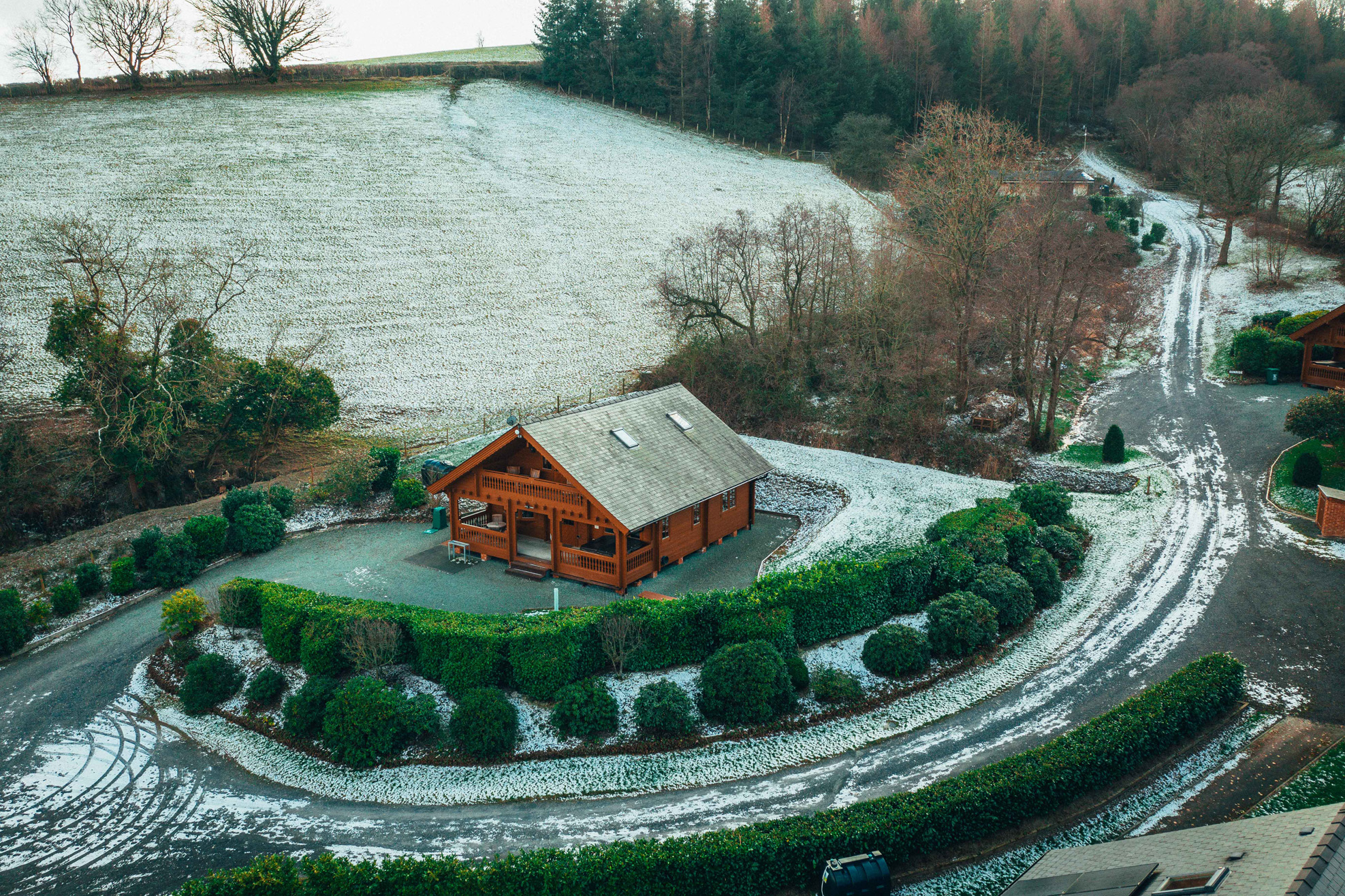 Ariel shot of Sunset luxury lodge in the winter with some light snow